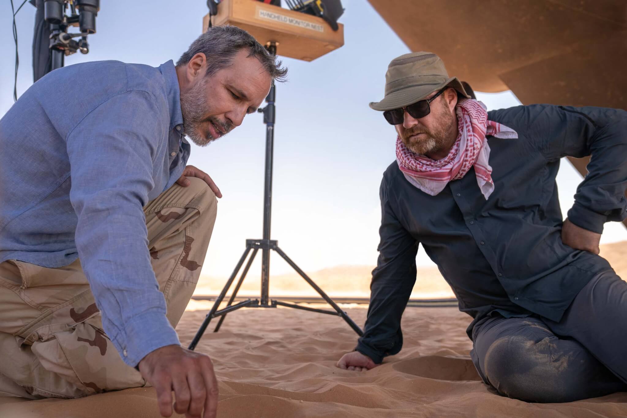 touching sand on set